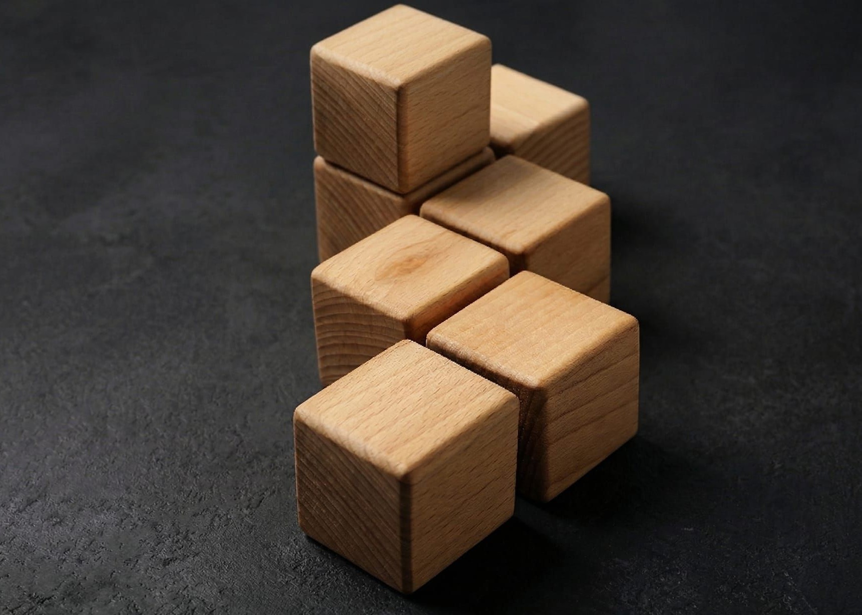 Stacked wooden blocks representing the building blocks of commercial banking primacy